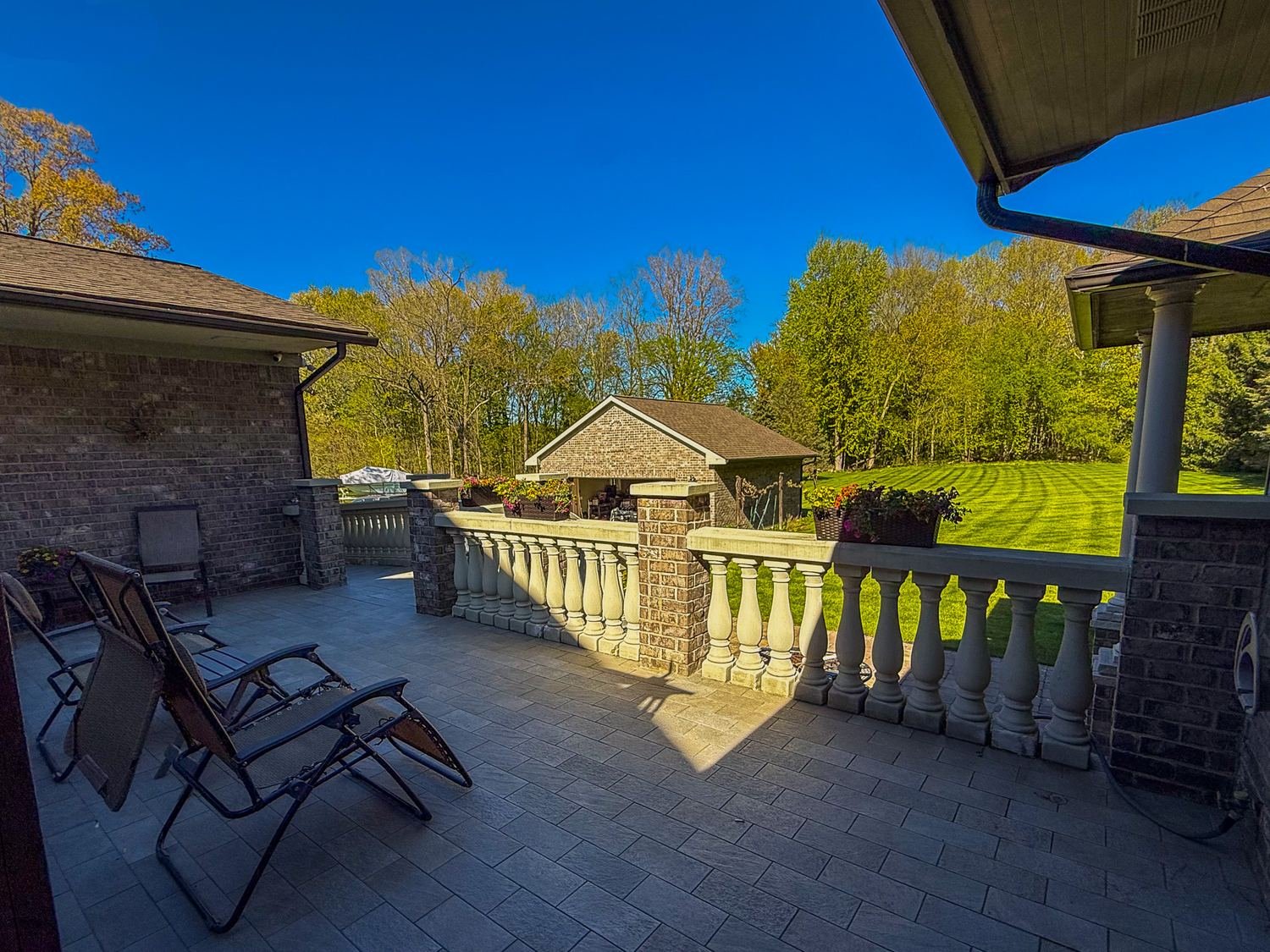Patio with balustrade and garden shed